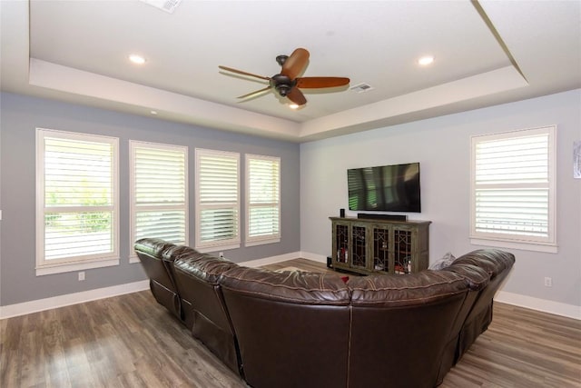 1328 Siena Sunset Rd, Leander, TX 78641 - living area featuring a raised ceiling, a ceiling fan, wood finished floors, healthy amount of natural light, and recessed lighting