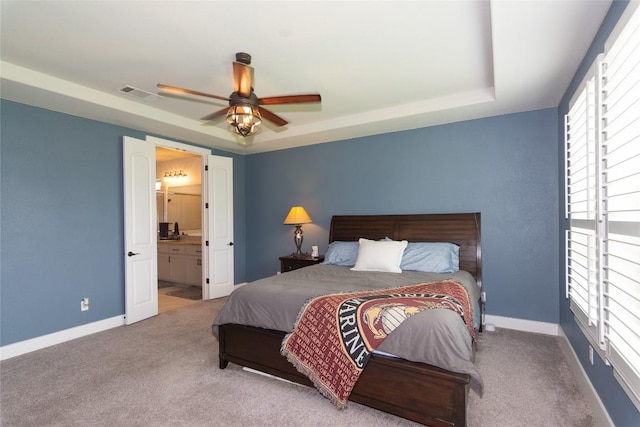 1328 Siena Sunset Rd, Leander, TX 78641 - carpeted bedroom with a raised ceiling, ensuite bath, and a ceiling fan