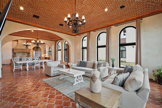 108 Country Vista Ln, Georgetown, TX 78626 - living room with arched walkways, a chandelier, brick ceiling, and recessed lighting