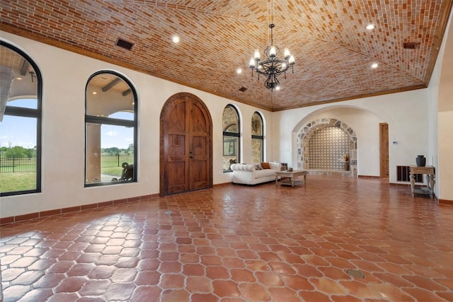 108 Country Vista Ln, Georgetown, TX 78626 - foyer featuring arched walkways, a chandelier, stone finish floors, and recessed lighting