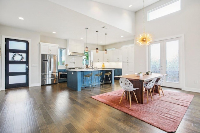 7000 Zachary Dr, Austin, TX 78724 - dining space with dark wood-style floors, a high ceiling, and recessed lighting