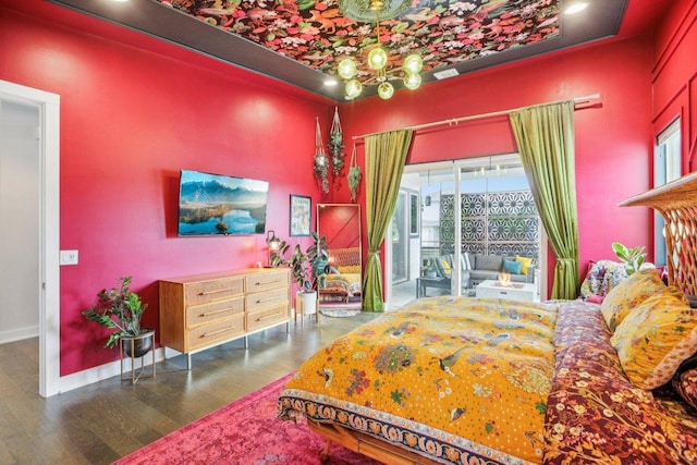 7000 Zachary Dr, Austin, TX 78724 - bedroom with wood finished floors, access to exterior, and a chandelier