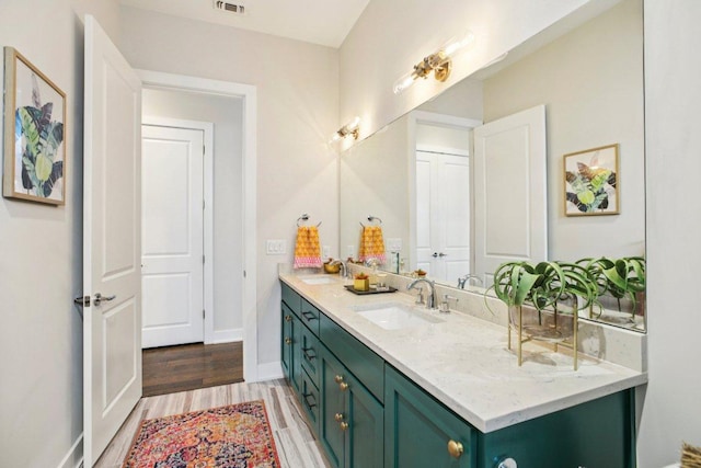 7000 Zachary Dr, Austin, TX 78724 - full bathroom featuring double vanity and wood finished floors