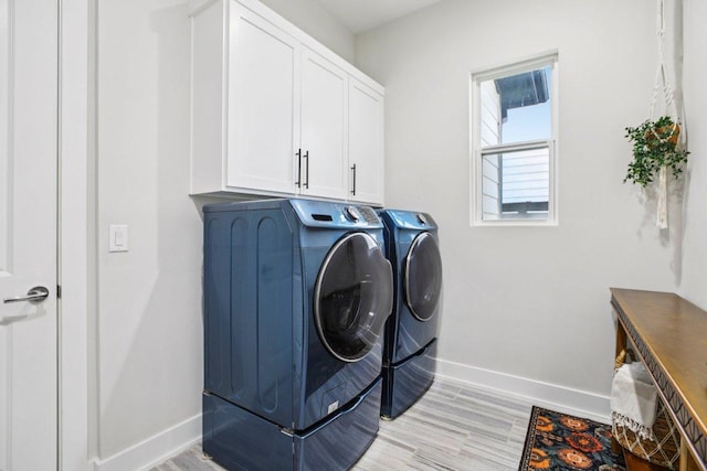 7000 Zachary Dr, Austin, TX 78724 - washroom with cabinet space, washer and dryer, and light wood finished floors