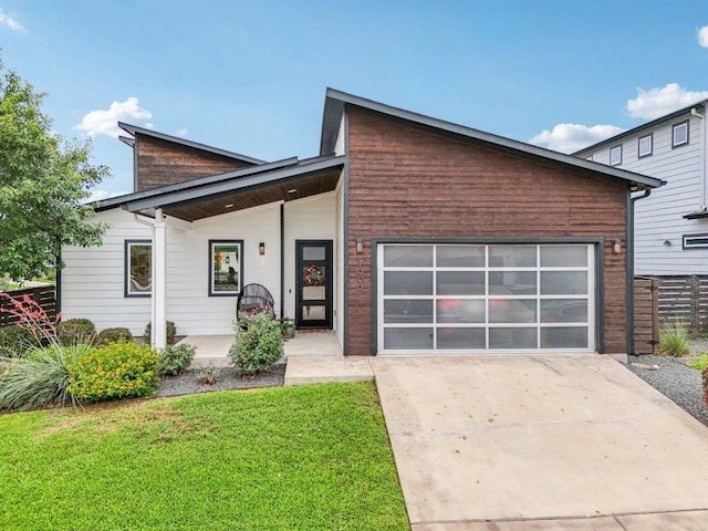 7000 Zachary Dr, Austin, TX 78724 - view of front facade featuring a garage, concrete driveway, and a porch