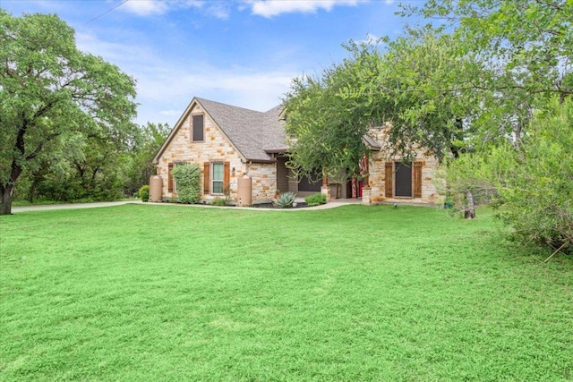 13 Mojave Ln, Belton, TX 76513 - view of front of home featuring stone siding, a front yard, and a shingled roof