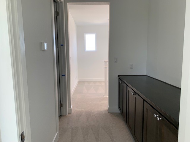 1104 Yaupon Holly Dr, Georgetown, TX 78628 - hallway with light colored carpet and baseboards