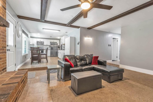 1102 Girard St, San Marcos, TX 78666 - living area featuring light tile patterned floors, beamed ceiling, a ceiling fan, and brick wall