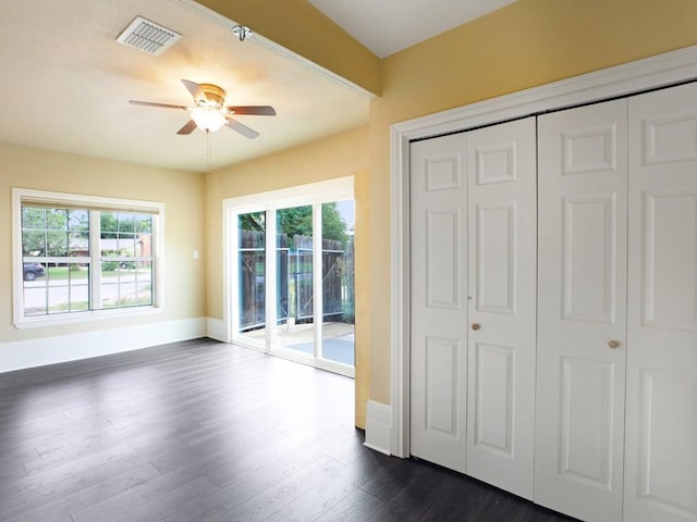 3811 Byron Dr, Austin, TX 78704 - unfurnished bedroom with access to outside, dark wood-type flooring, ceiling fan, and a closet