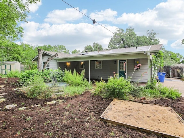 3811 Byron Dr, Austin, TX 78704 - rear view of property featuring a storage shed and solar panels