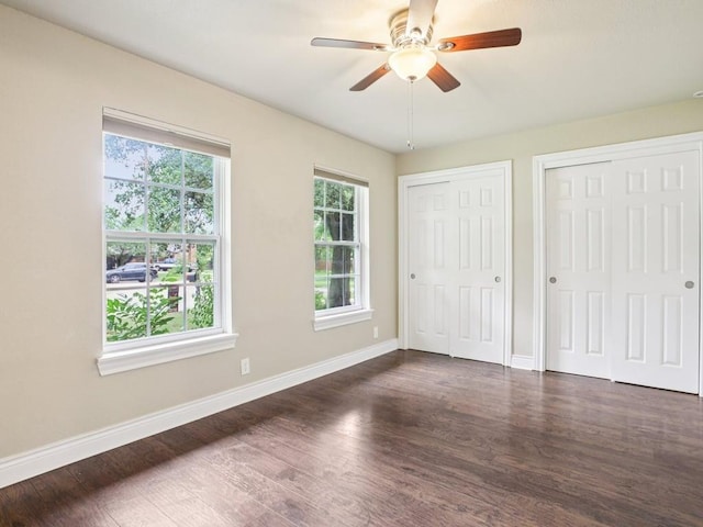 3811 Byron Dr, Austin, TX 78704 - unfurnished bedroom with multiple closets, dark wood finished floors, and ceiling fan