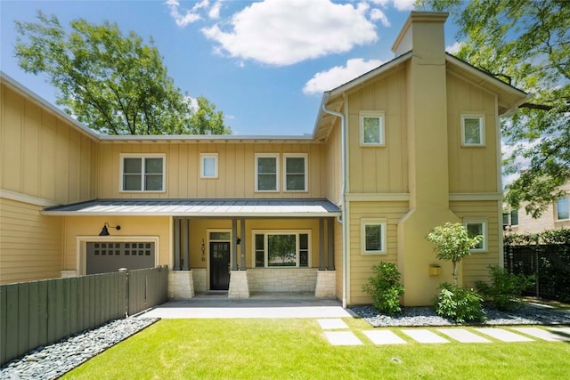 1403 W 12th St Unit B, Austin, TX 78703 - rear view of property featuring a chimney, a standing seam roof, a metal roof, and a porch