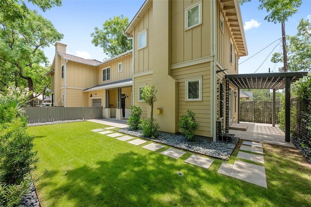 1403 W 12th St Unit B, Austin, TX 78703 - back of house with board and batten siding, a patio, and a chimney