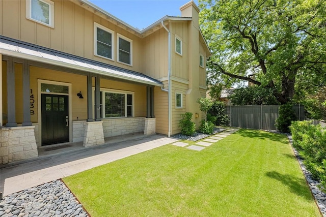 1403 W 12th St Unit B, Austin, TX 78703 - view of front of home featuring a standing seam roof, a chimney, a metal roof, and stone siding