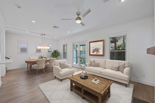 1403 W 12th St Unit B, Austin, TX 78703 - living room with light wood-style floors, ceiling fan, recessed lighting, and crown molding
