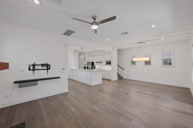 1403 W 12th St Unit B, Austin, TX 78703 - unfurnished living room with ceiling fan, light wood-style flooring, stairs, and recessed lighting