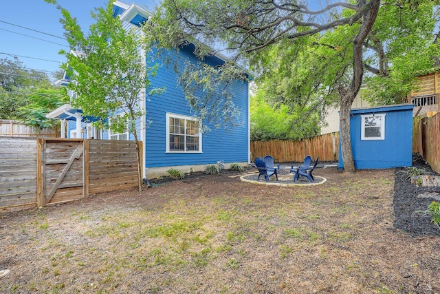 1117 Algarita Ave, Austin, TX 78704 - fenced backyard featuring an outdoor fire pit and an outdoor structure