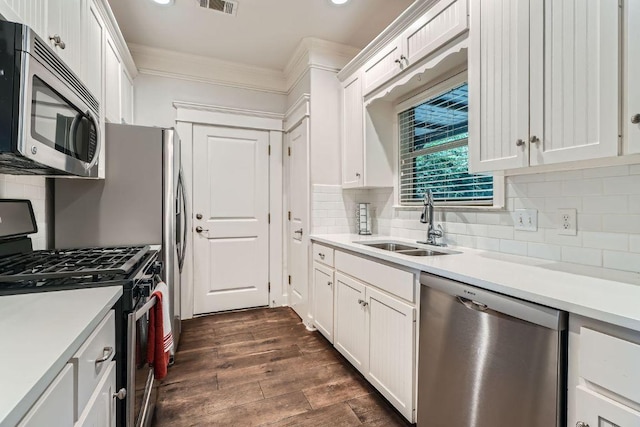 1117 Algarita Ave, Austin, TX 78704 - kitchen with stainless steel appliances, crown molding, light countertops, white cabinets, and recessed lighting