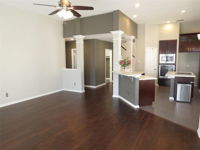 4008 Sable Oaks Dr, Round Rock, TX 78664 - kitchen featuring stainless steel appliances, ceiling fan, light countertops, dark wood finished floors, and a peninsula