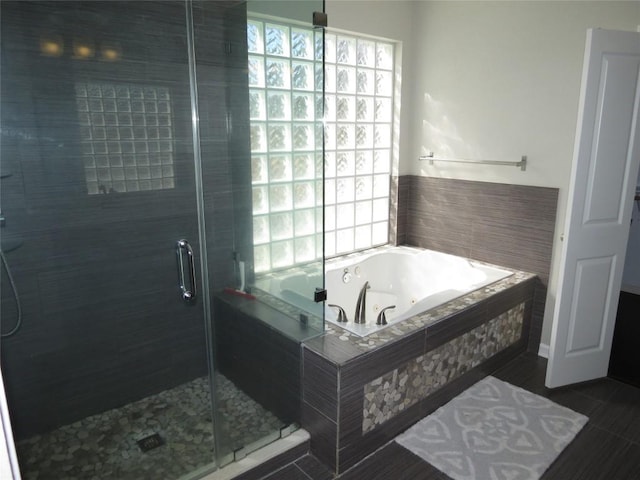 4008 Sable Oaks Dr, Round Rock, TX 78664 - bathroom featuring plenty of natural light, a tub with jets, and a stall shower