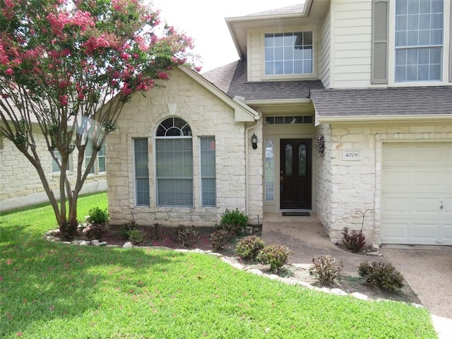 4008 Sable Oaks Dr, Round Rock, TX 78664 - property entrance featuring stone siding, an attached garage, a shingled roof, and a lawn