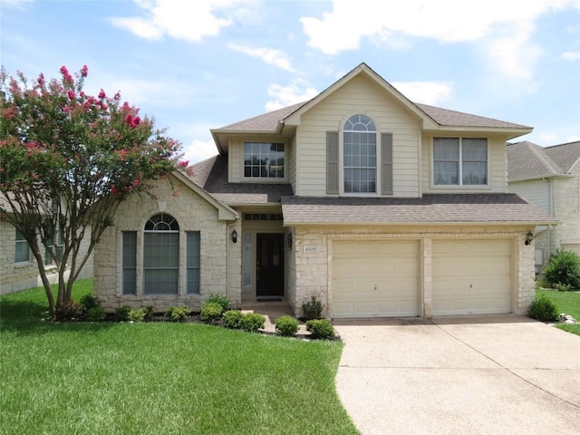 4008 Sable Oaks Dr, Round Rock, TX 78664 - view of front of home featuring stone siding, concrete driveway, roof with shingles, and a front yard