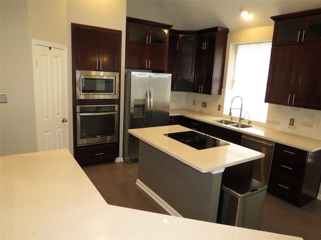 4008 Sable Oaks Dr, Round Rock, TX 78664 - kitchen featuring appliances with stainless steel finishes, dark wood-style floors, light countertops, lofted ceiling, and glass insert cabinets
