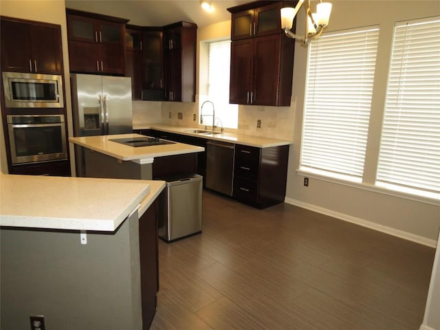 4008 Sable Oaks Dr, Round Rock, TX 78664 - kitchen with appliances with stainless steel finishes, light countertops, a center island, a chandelier, and glass insert cabinets