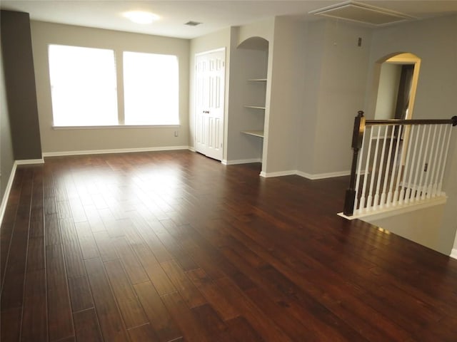 4008 Sable Oaks Dr, Round Rock, TX 78664 - spare room with dark wood-style floors, arched walkways, and attic access