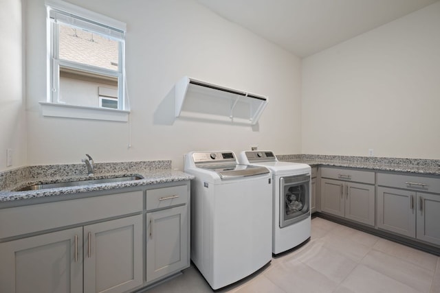 4628 Vieste Vw, Leander, TX 78641 - washroom featuring independent washer and dryer, cabinet space, and light tile patterned floors
