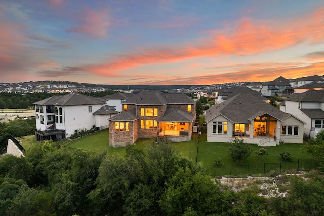 4628 Vieste Vw, Leander, TX 78641 - back of house at dusk featuring a fenced backyard, a residential view, and a patio