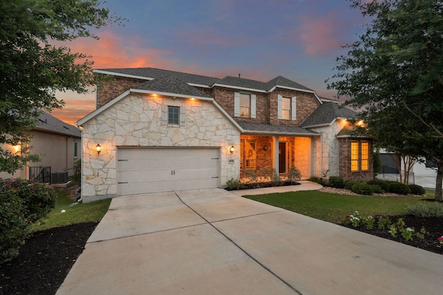 4628 Vieste Vw, Leander, TX 78641 - view of front facade with stone siding, driveway, a garage, and a front lawn