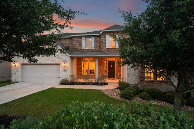 4628 Vieste Vw, Leander, TX 78641 - traditional-style house with stone siding, concrete driveway, a front lawn, an attached garage, and roof with shingles