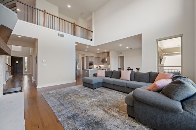 4628 Vieste Vw, Leander, TX 78641 - living room featuring a high ceiling, wood finished floors, and stairway