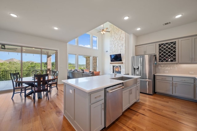 4628 Vieste Vw, Leander, TX 78641 - kitchen featuring appliances with stainless steel finishes, gray cabinetry, a ceiling fan, light wood-style flooring, and recessed lighting