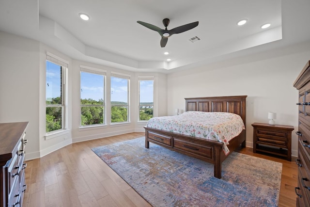 4628 Vieste Vw, Leander, TX 78641 - bedroom featuring a raised ceiling, light wood-style floors, recessed lighting, and a ceiling fan