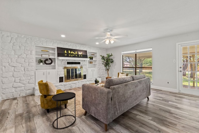 4003 Park Dr, Round Rock, TX 78681 - living area with a fireplace, plenty of natural light, ceiling fan, wood finished floors, and recessed lighting