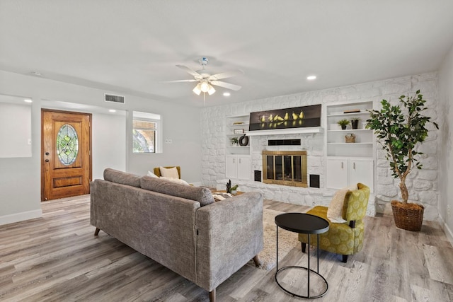 4003 Park Dr, Round Rock, TX 78681 - living room with ceiling fan, wood finished floors, a fireplace, built in features, and recessed lighting
