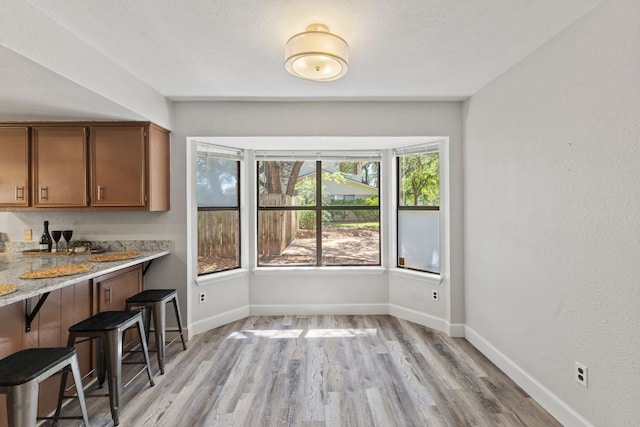 4003 Park Dr, Round Rock, TX 78681 - unfurnished dining area featuring light wood finished floors and bar