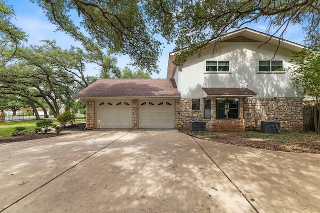 4003 Park Dr, Round Rock, TX 78681 - view of front facade with stone siding, an attached garage, concrete driveway, and roof with shingles