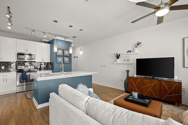 1900 Barton Springs Rd Unit 3038, Austin, TX 78704 - living room featuring ceiling fan, wood finished floors, and crown molding