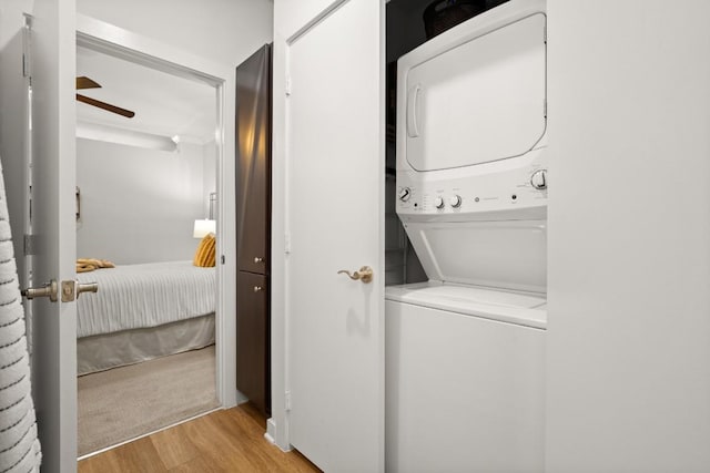 1900 Barton Springs Rd Unit 3038, Austin, TX 78704 - washroom with stacked washer and clothes dryer, light wood-style flooring, and a ceiling fan