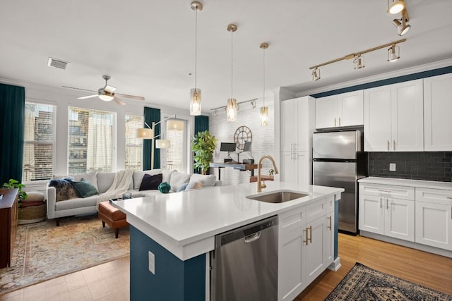 1900 Barton Springs Rd Unit 3038, Austin, TX 78704 - kitchen featuring appliances with stainless steel finishes, open floor plan, plenty of natural light, and light wood-type flooring