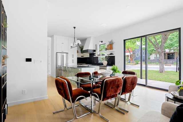 4911 Duval, Austin, TX 78751 - dining space featuring light wood-style floors and baseboards