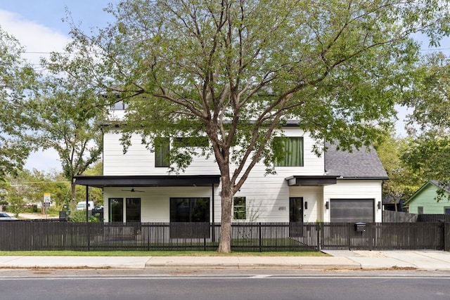 4911 Duval, Austin, TX 78751 - view of front of home with a fenced front yard, ceiling fan, and a garage
