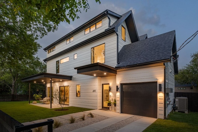 4911 Duval, Austin, TX 78751 - contemporary house with driveway, roof with shingles, a garage, and a patio area