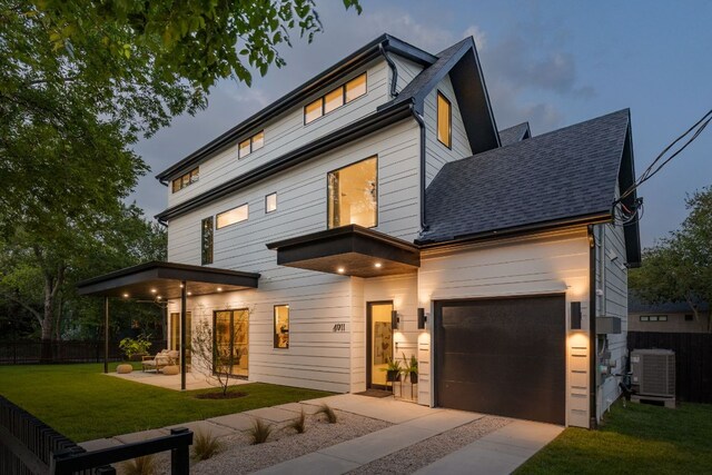 4911 Duval, Austin, TX 78751 - contemporary home with concrete driveway, roof with shingles, a garage, and a patio