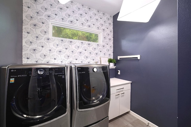 1303 Deloney St, Austin, TX 78721 - washroom featuring separate washer and dryer, wallpapered walls, and cabinet space