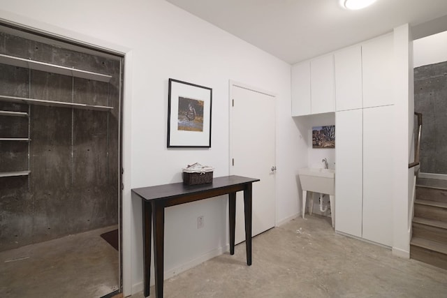 1303 Deloney St, Austin, TX 78721 - corridor featuring concrete floors and stairs