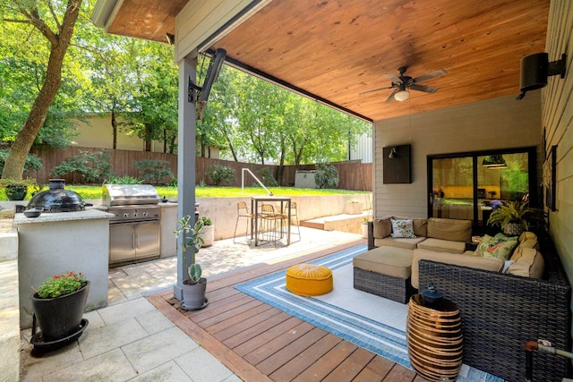 1303 Deloney St, Austin, TX 78721 - fenced backyard featuring exterior kitchen, an outdoor hangout area, ceiling fan, and a patio